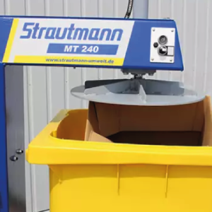 A wheelie bin plate compactor over a wheelie bin filled with cardboard.